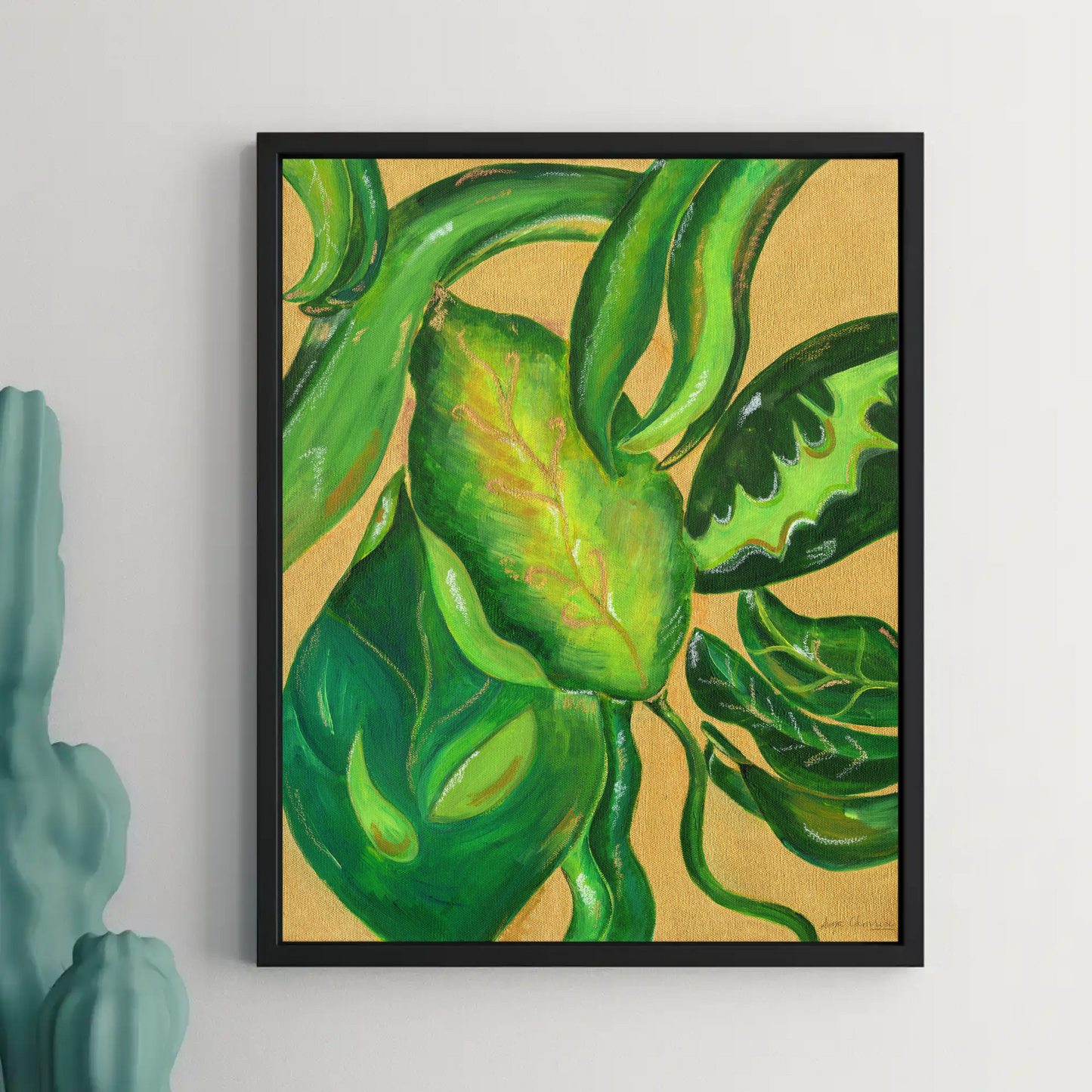 Framed painting of green leaves on a beige background