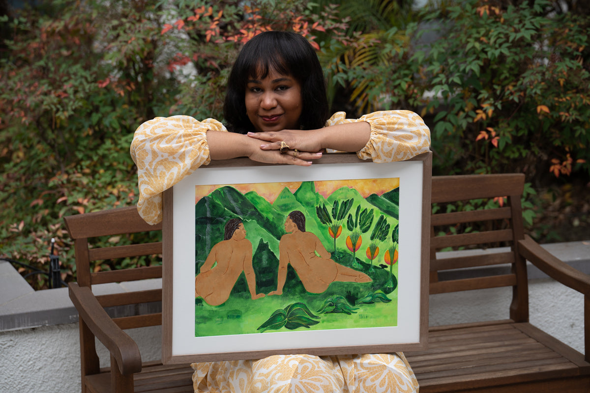 Artist Anya Cherrice holding Where the Sun Rests — original acrylic painting in a natural wood frame